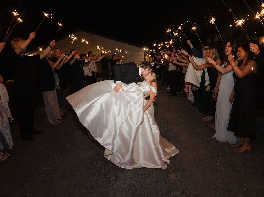 Newlyweds embrace under sparklers during sparkler send-off at Serenity Ridge, Lake Lure