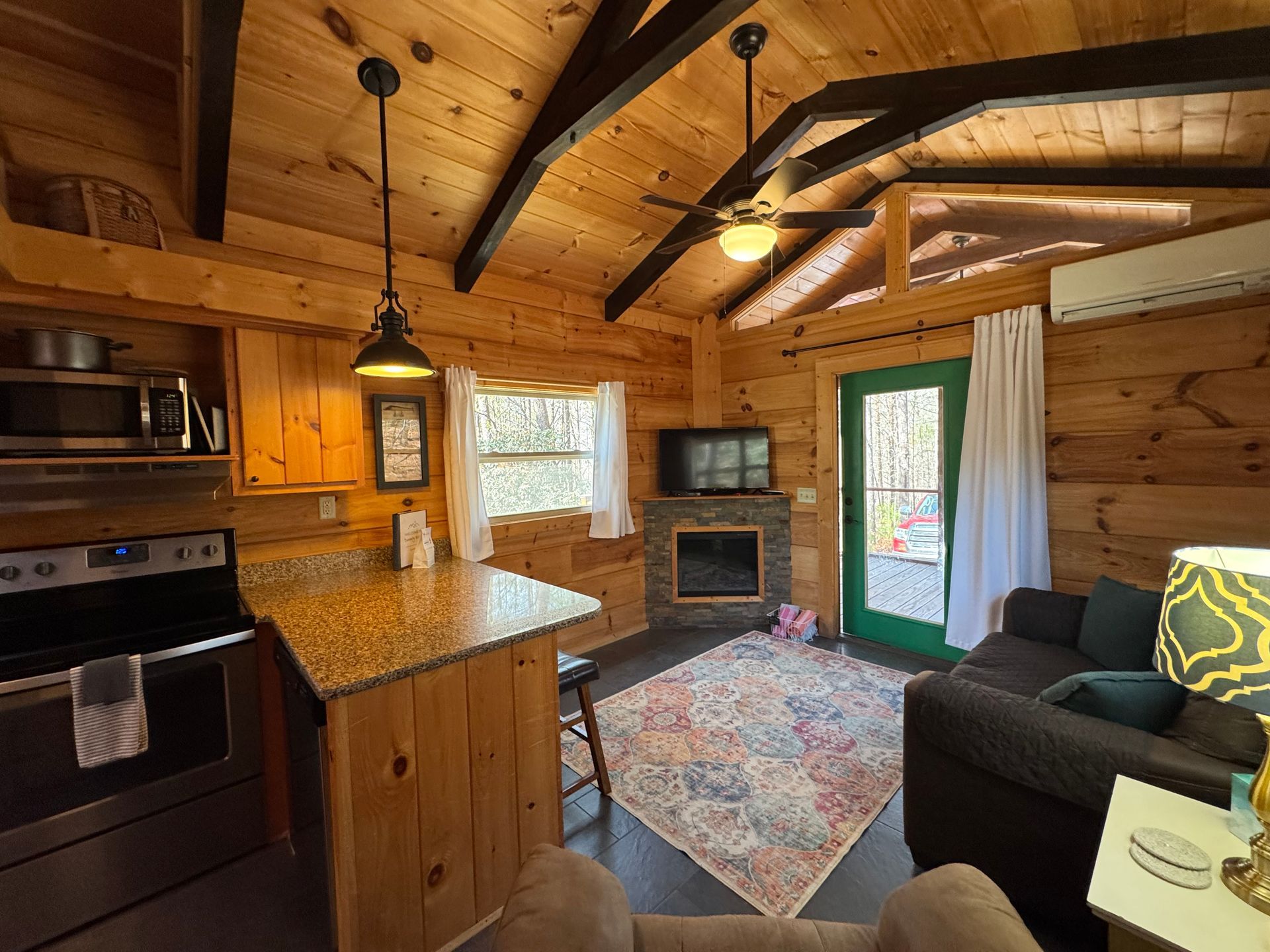 Living room with electric fireplace and smart TV in Cabin F at Serenity Ridge