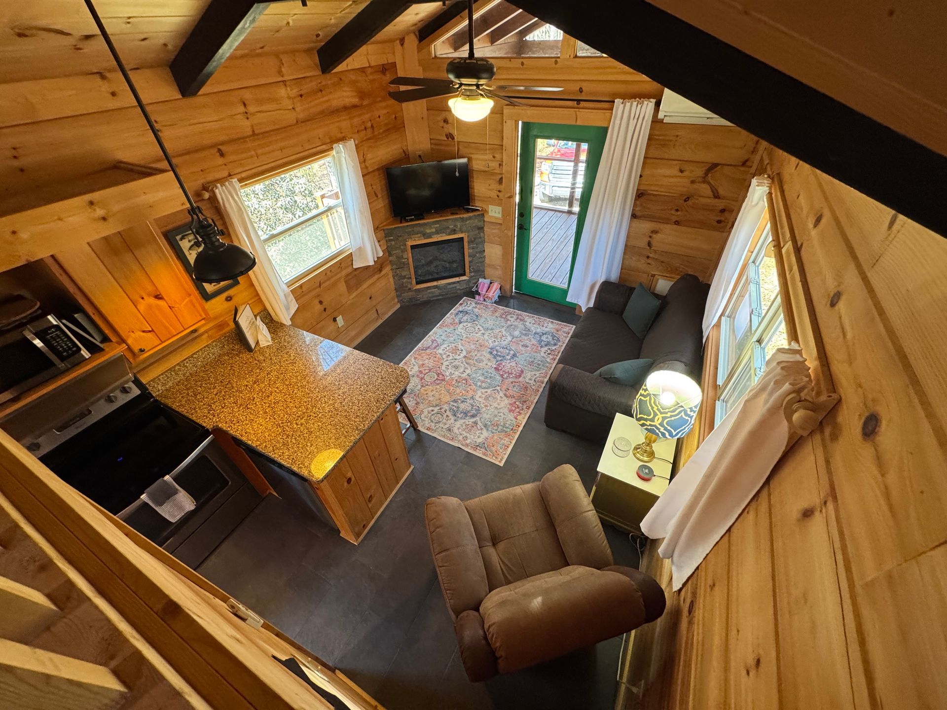 View looking down from loft into living room in Cabin F at Serenity Ridge