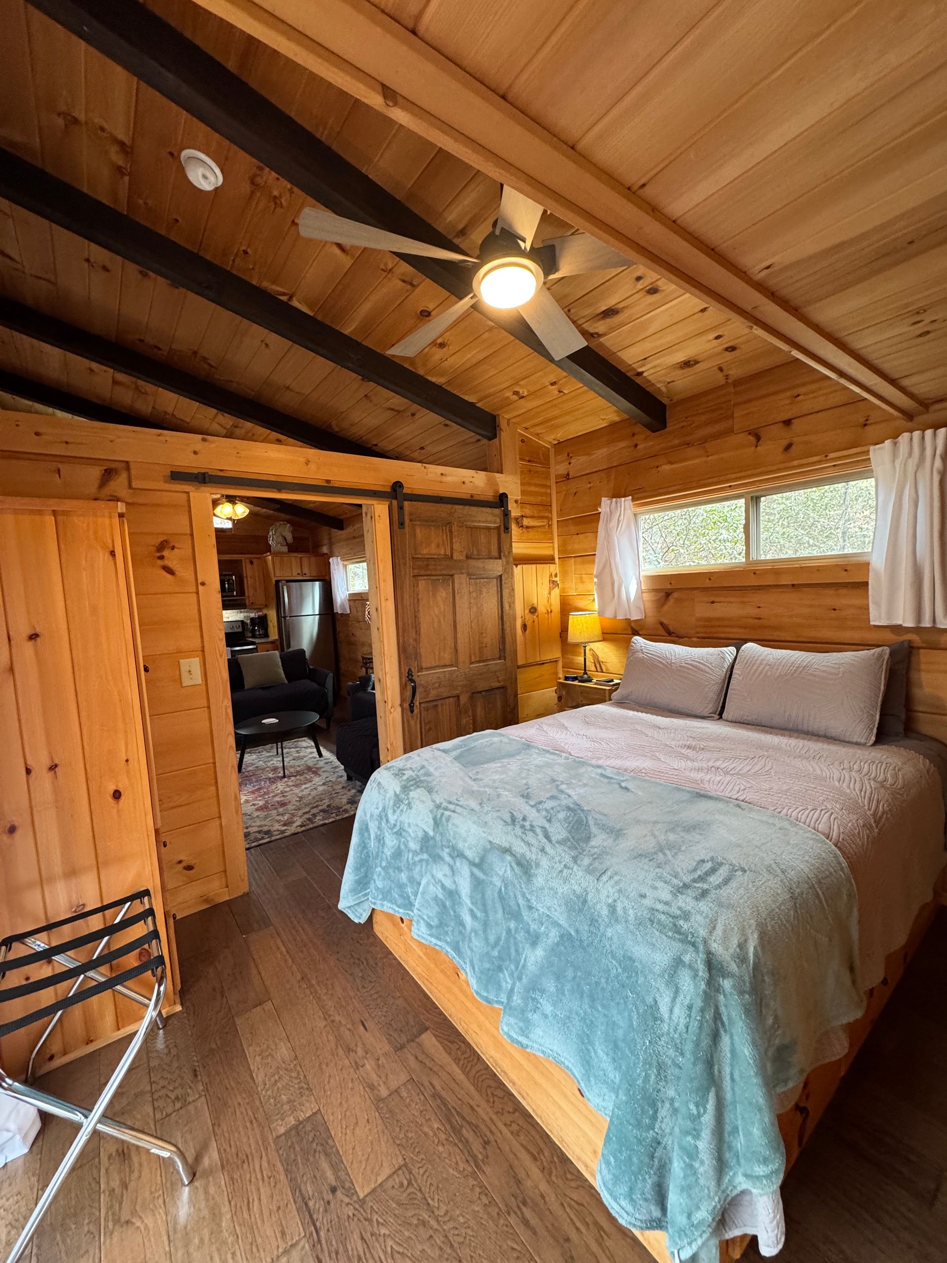 Bedroom in Cabin E with sliding door to screened porch at Serenity Ridge