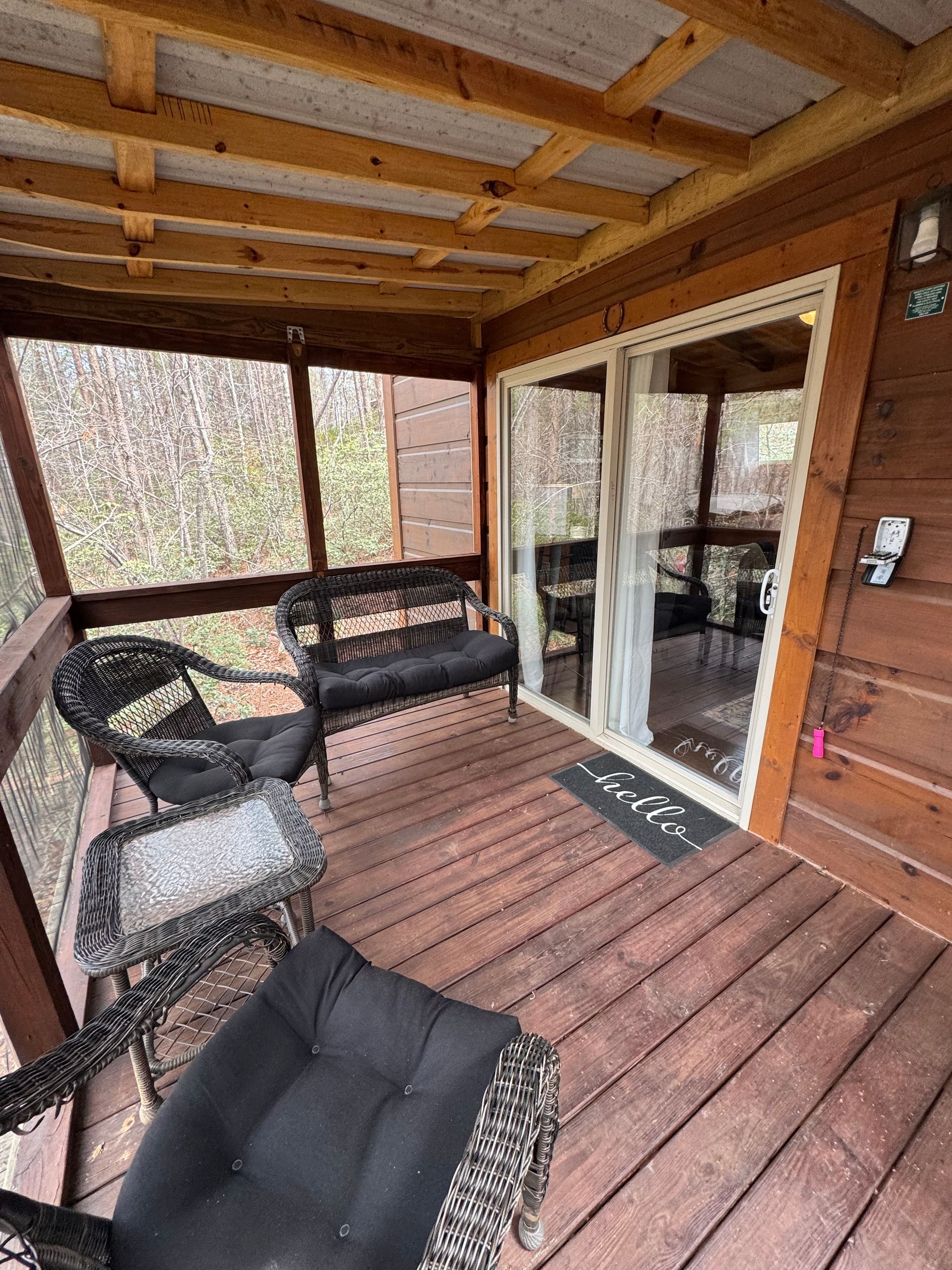 Private porch at Cabin E surrounded by nature at Serenity Ridge