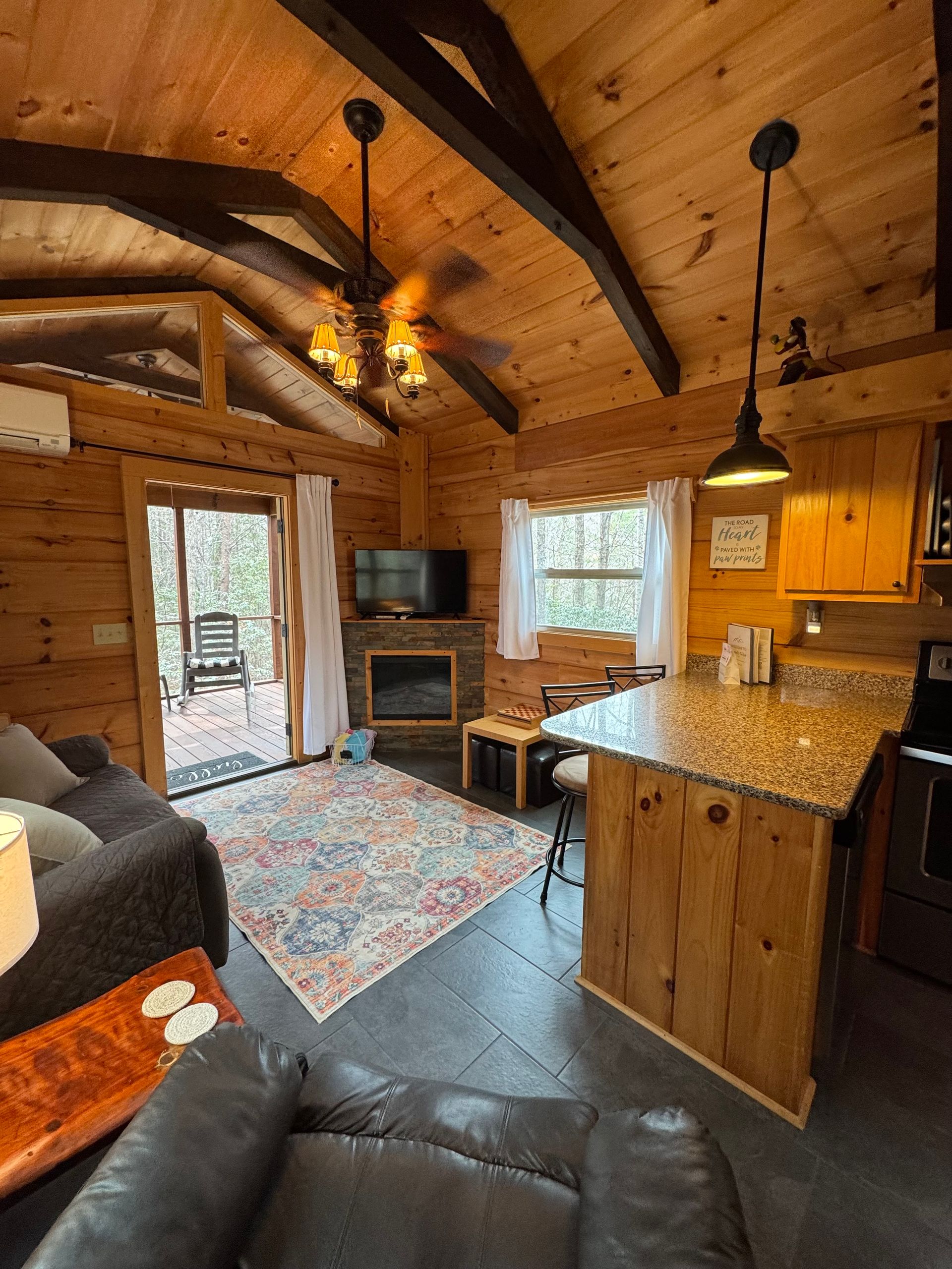 Living room with electric fireplace and smart TV in Cabin D at Serenity Ridge wedding lodging