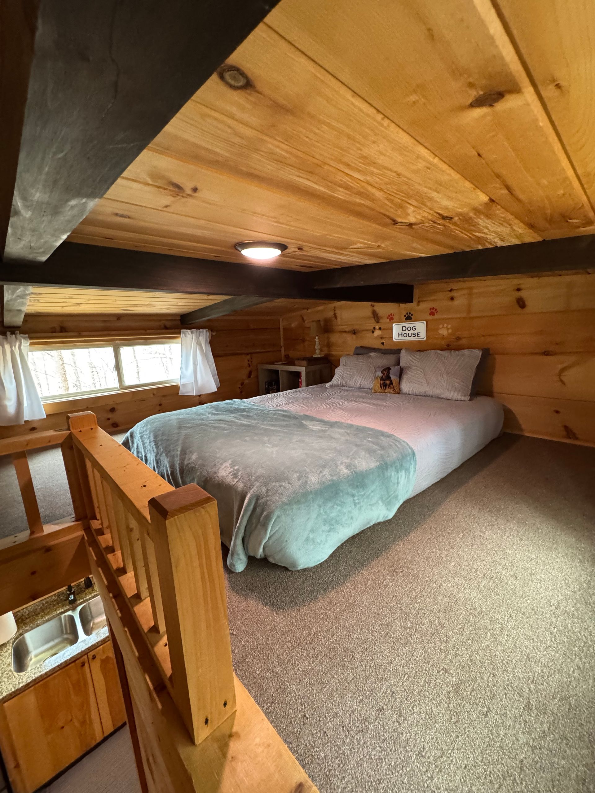 Loft bedroom with queen bed in Cabin D at Serenity Ridge mountain wedding venue