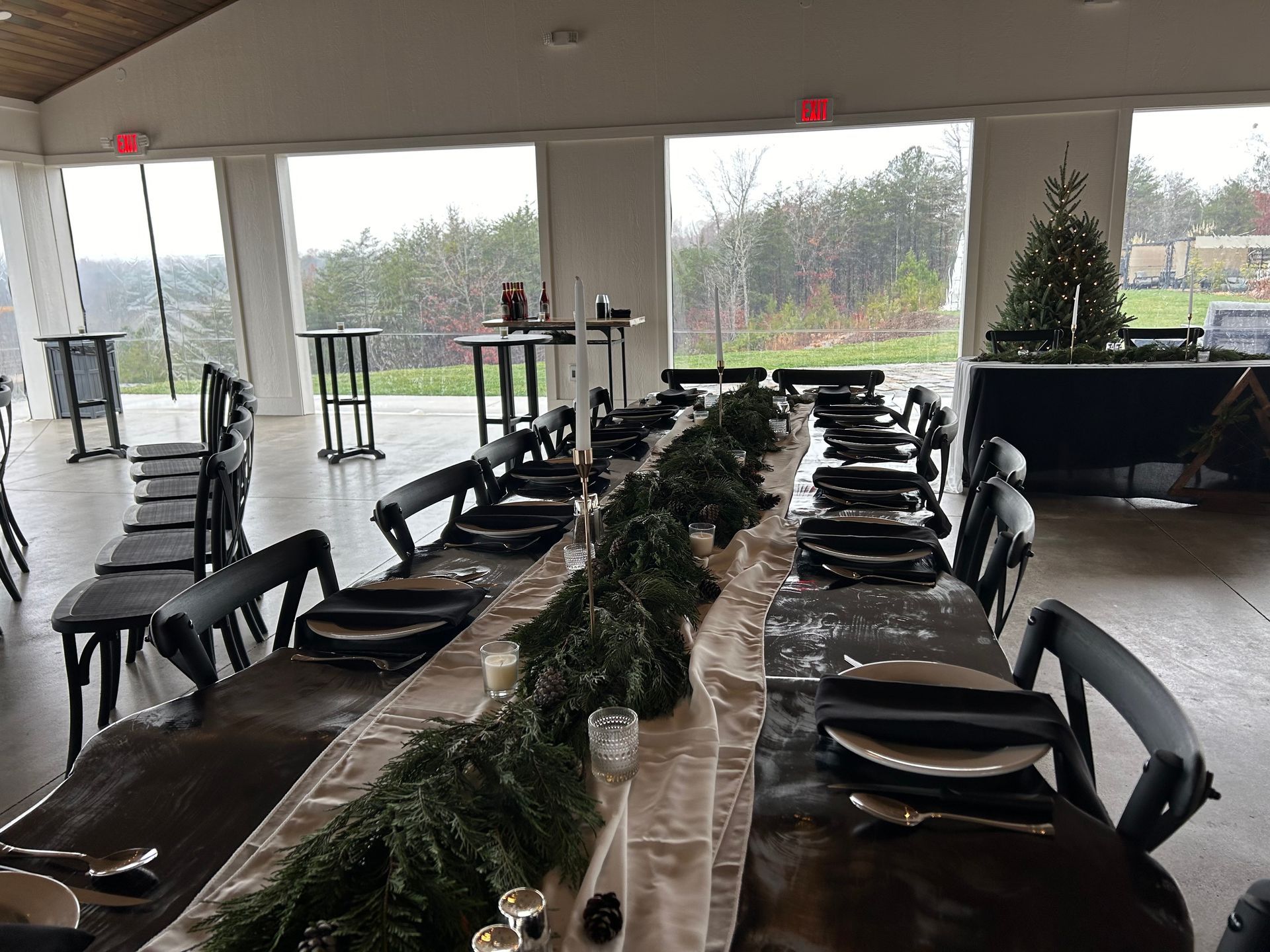 Reception under event pavilion featuring live-edge tables and X-Back chairs at Serenity Ridge