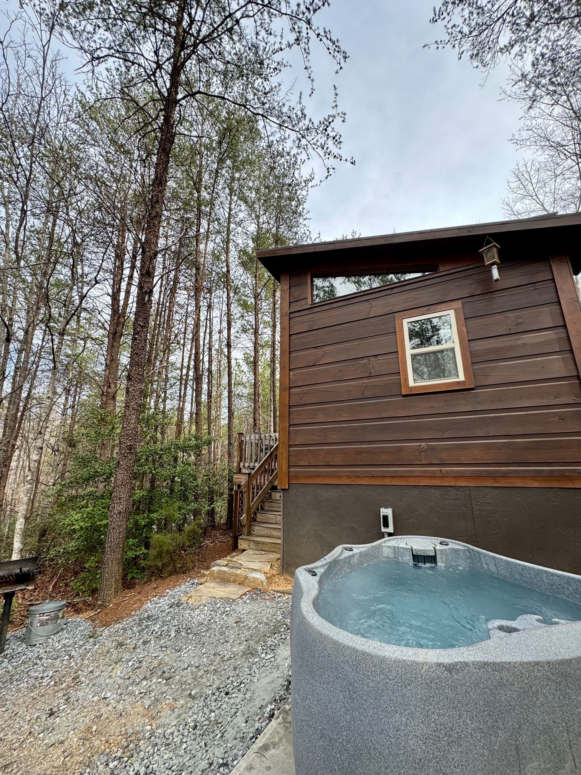 Cabin E exterior with private hot tub at Serenity Ridge wedding venue lodging