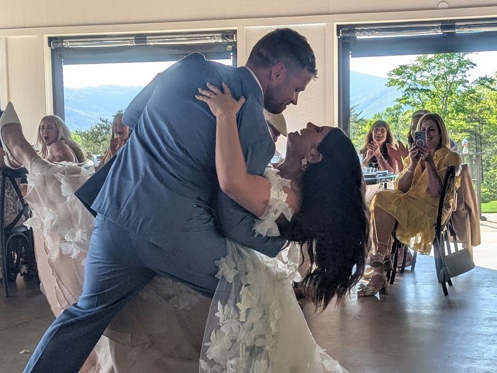 Couple’s first dance in bright event pavilion with mountain views at Serenity Ridge, Asheville area