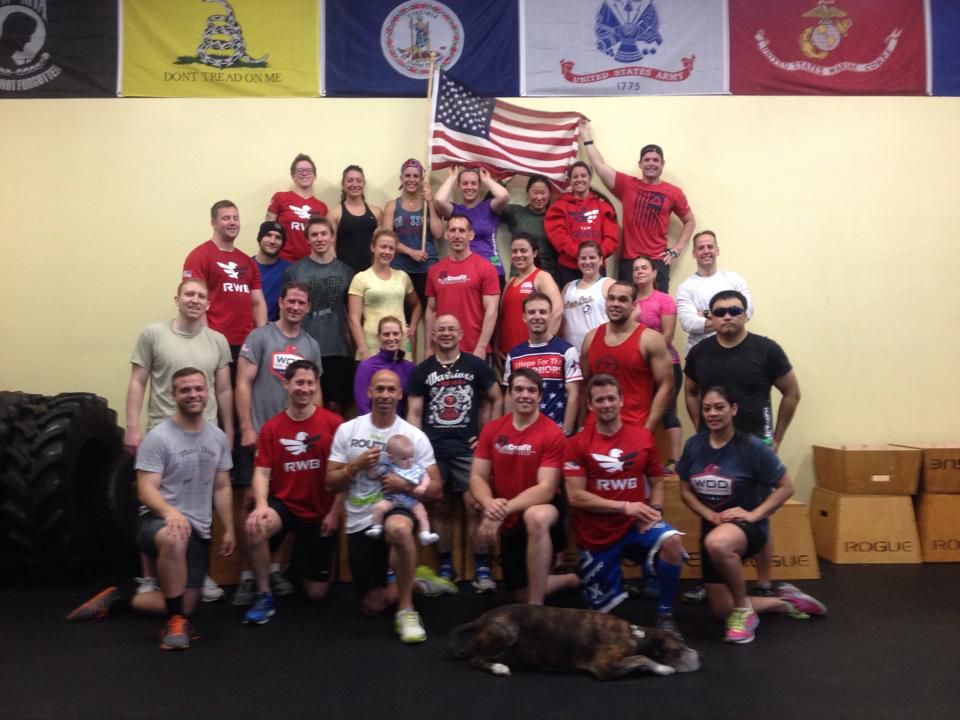 A group of people posing for a picture in front of flags