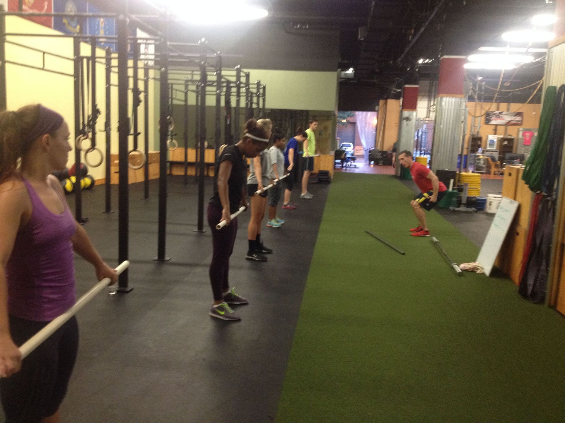 A man is doing push ups with a trainer in a gym