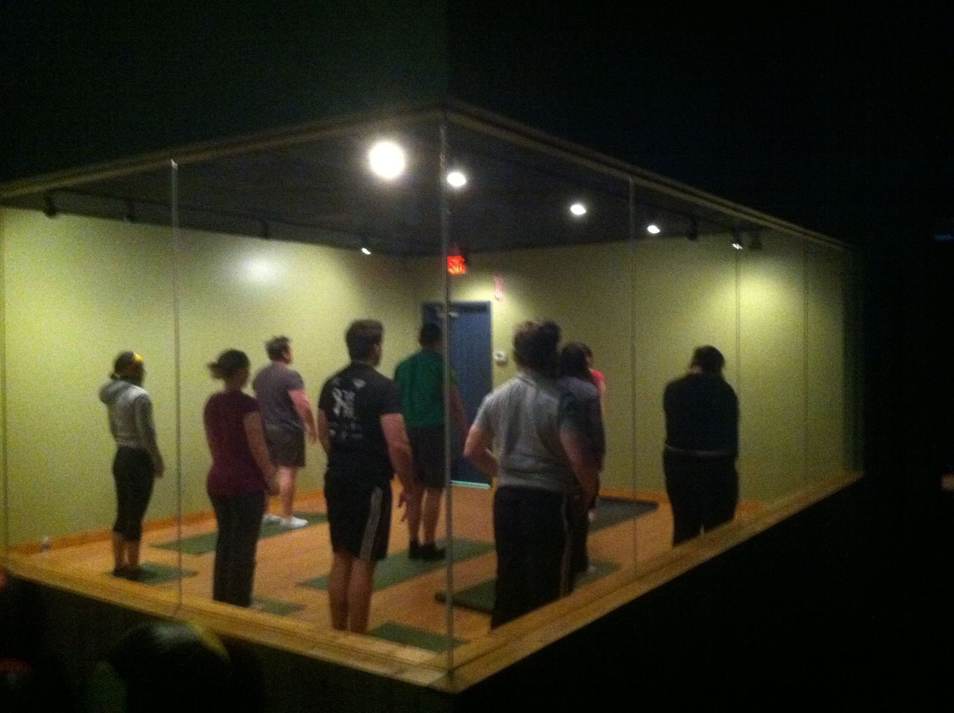 A group of people standing in a room with a man wearing a NY shirt