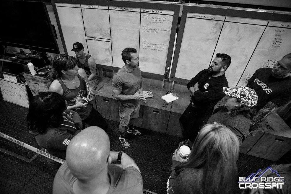 A group of people are standing around a table in a black and white photo