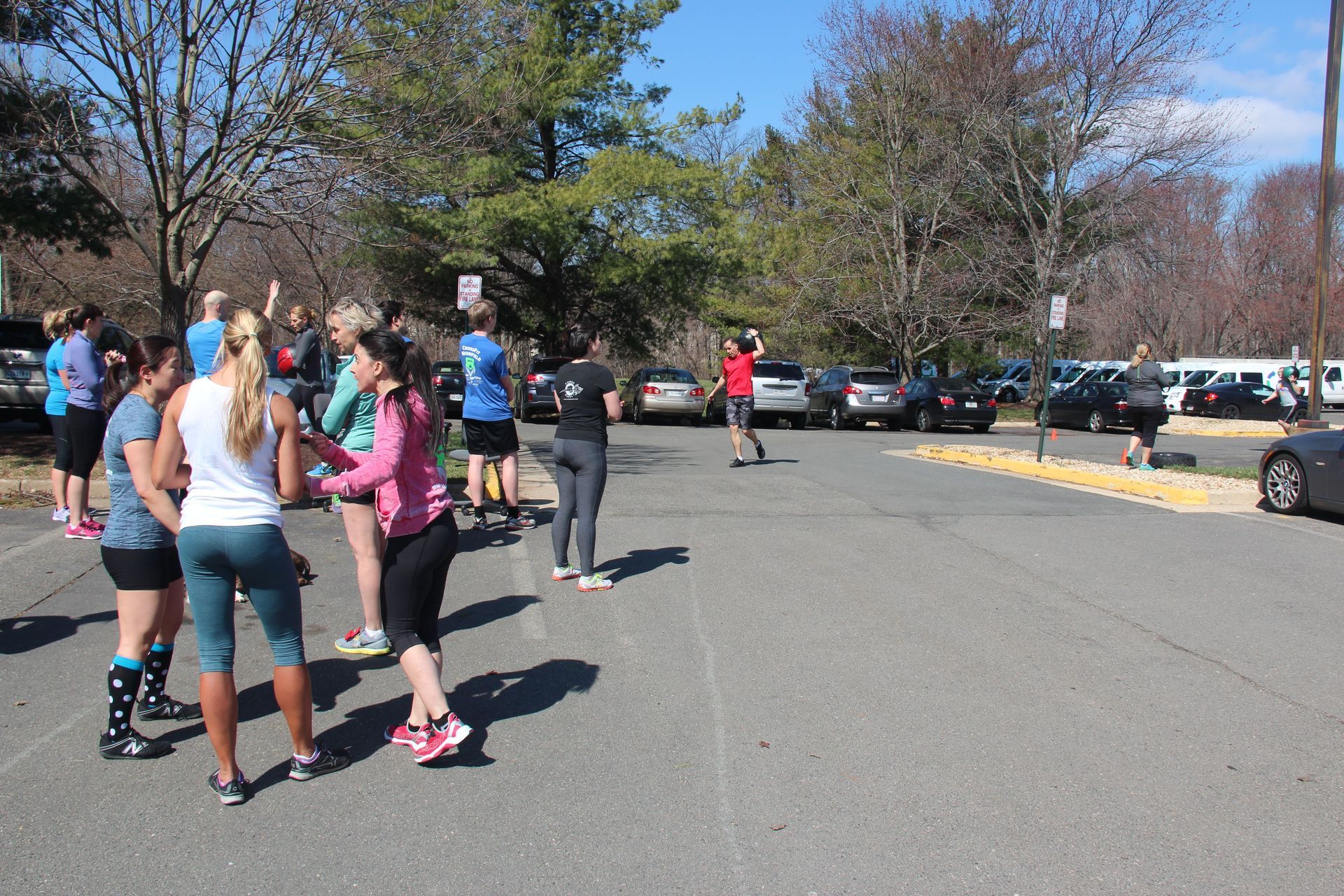 A group of people are standing in a parking lot