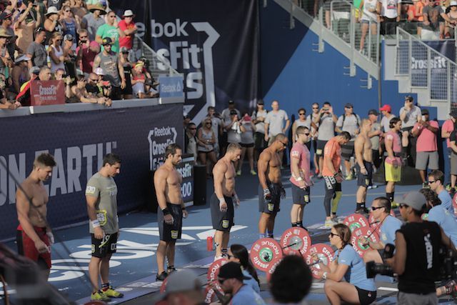 A group of people standing in front of a reebok sign