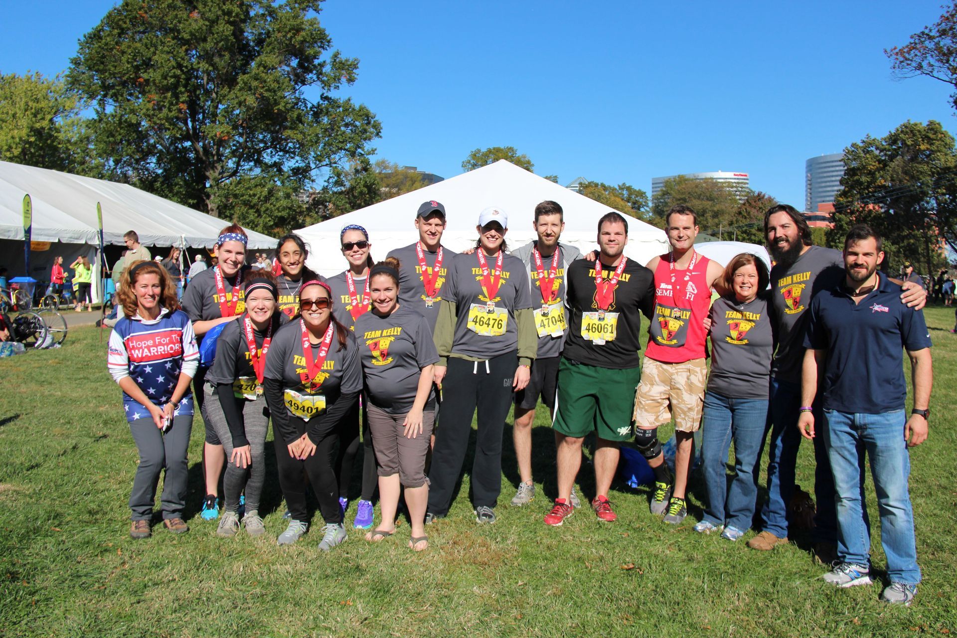 A group of people are posing for a picture in a field