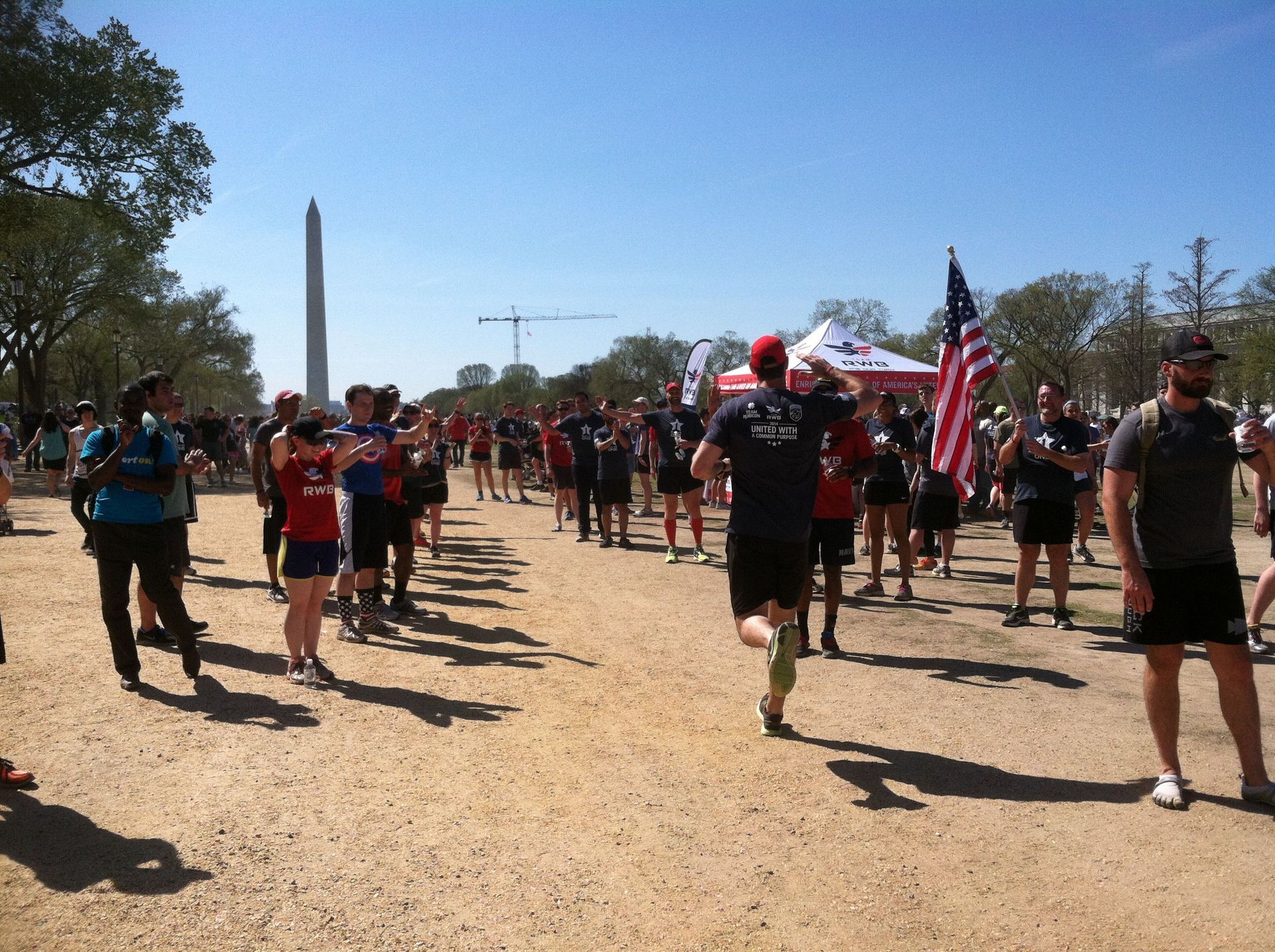 A group of people are running on a dirt road