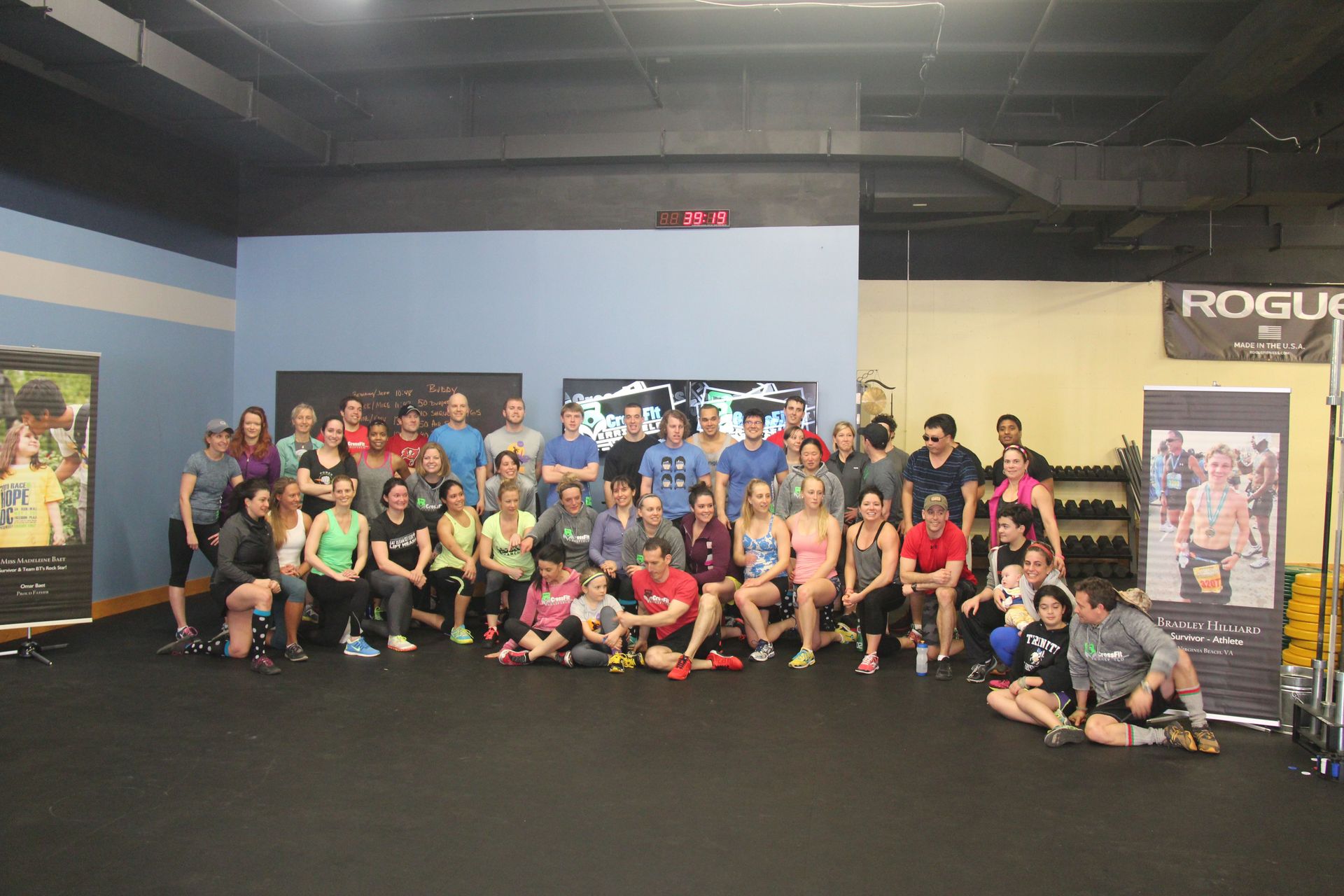 A group of people are posing for a picture in a gym