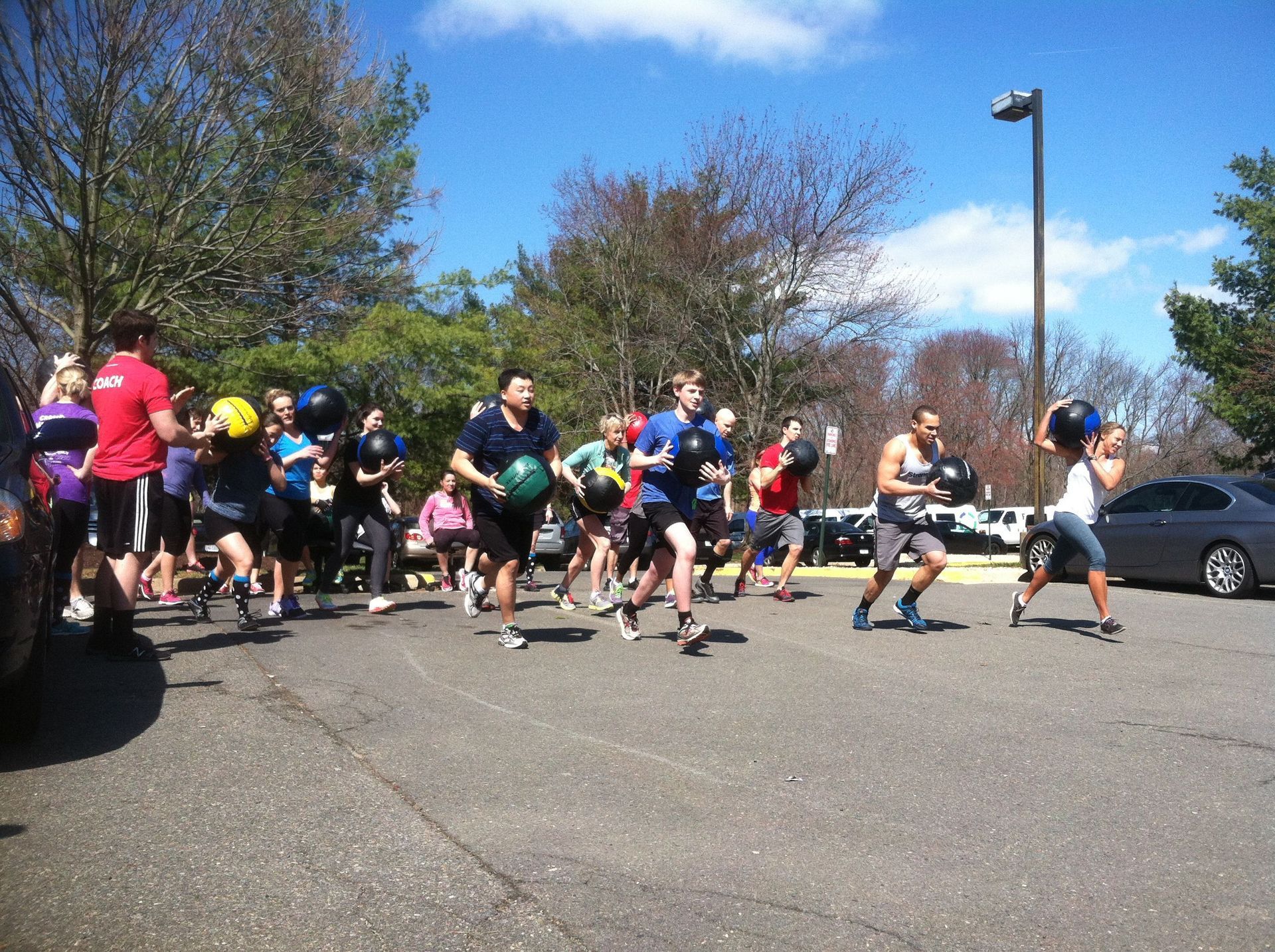 A group of people are running in a parking lot
