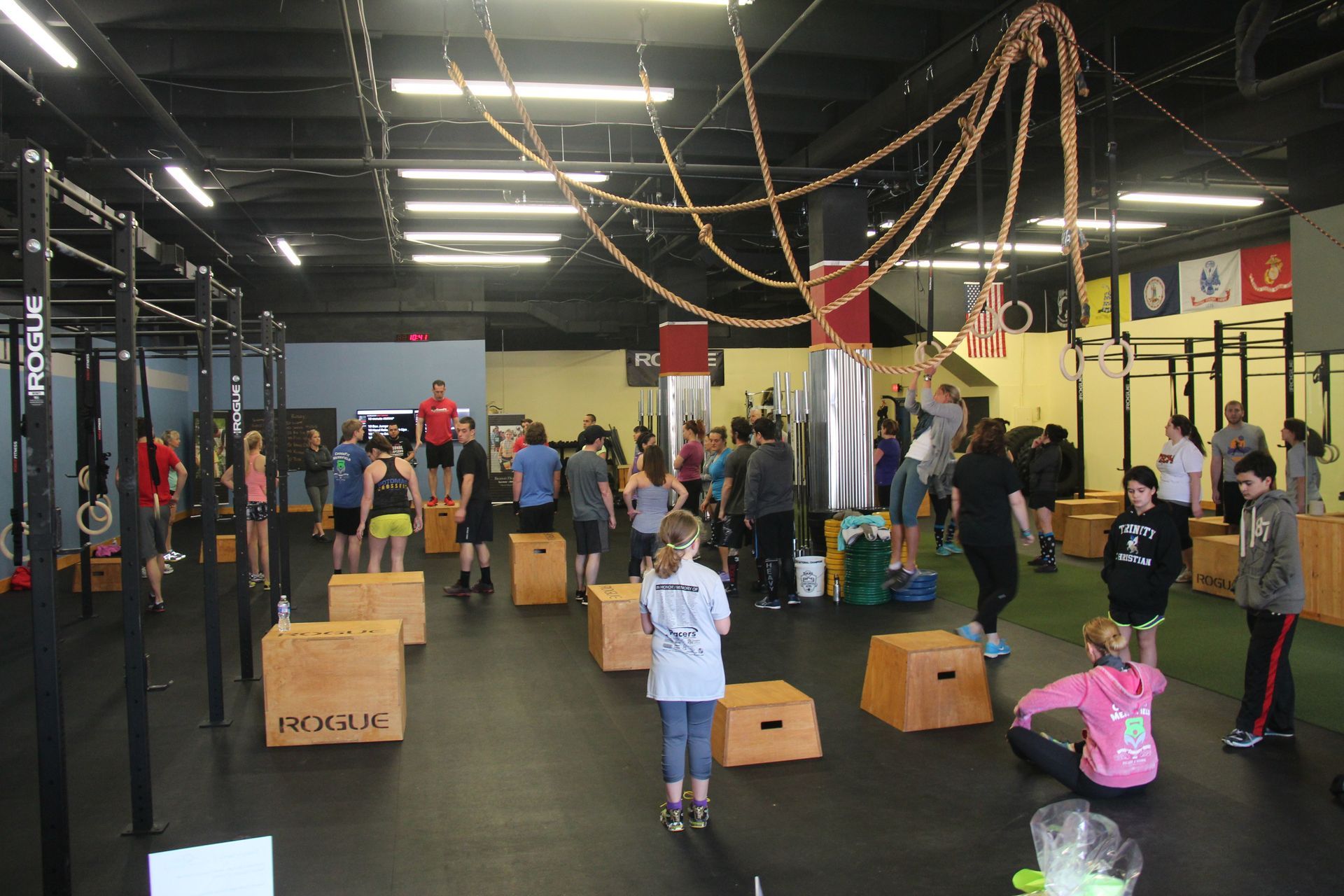 A group of people are doing exercises in a gym