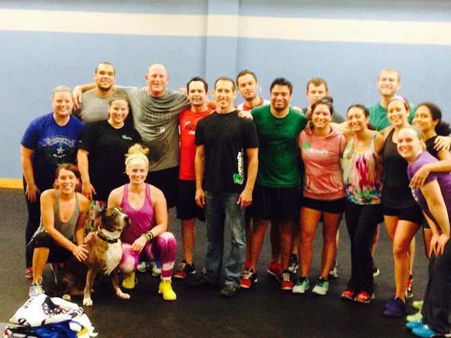 A group of people posing for a picture with a dog