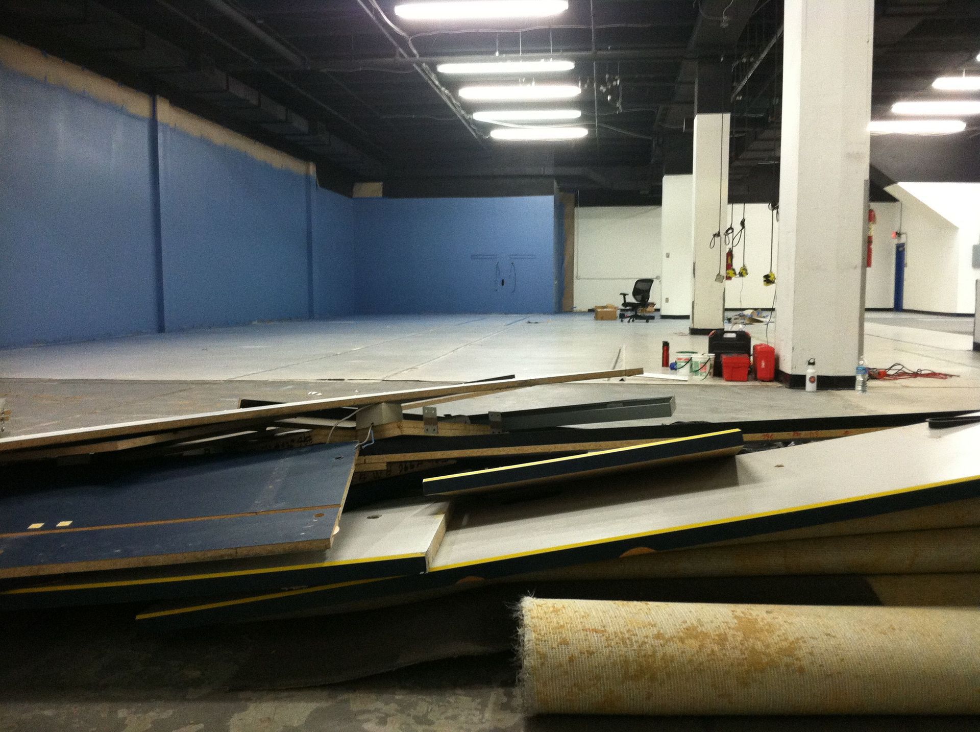 An empty room with a lot of pieces of wood on the floor