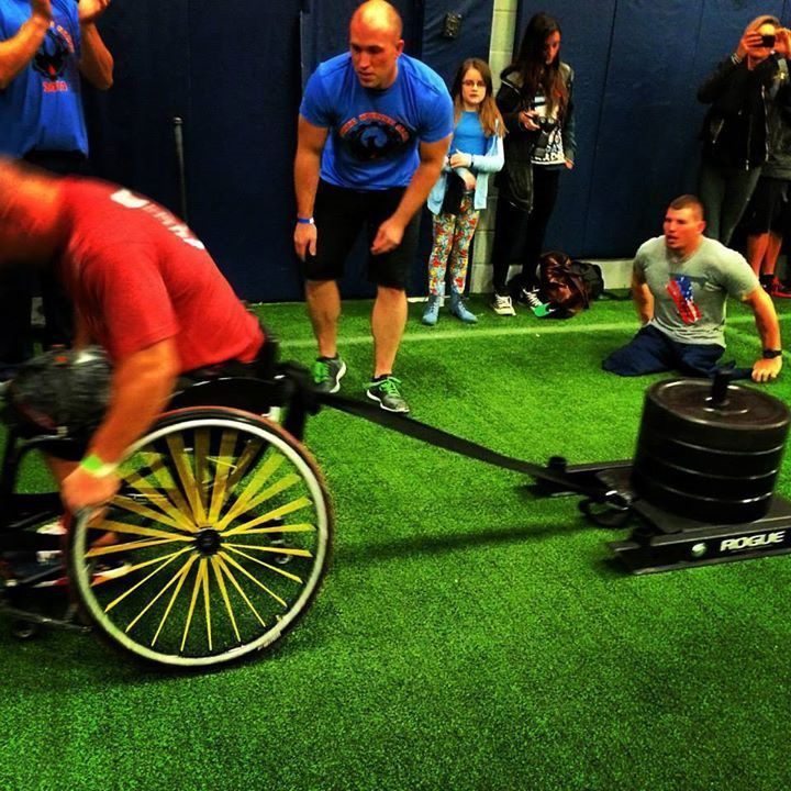 A man in a wheelchair is being pulled by a rogue machine