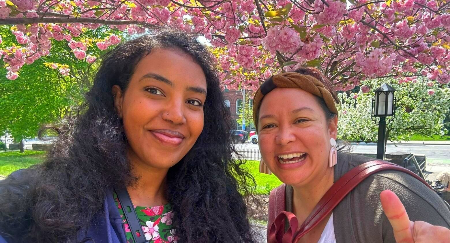 a woman is holding another woman 's hand while sitting down .