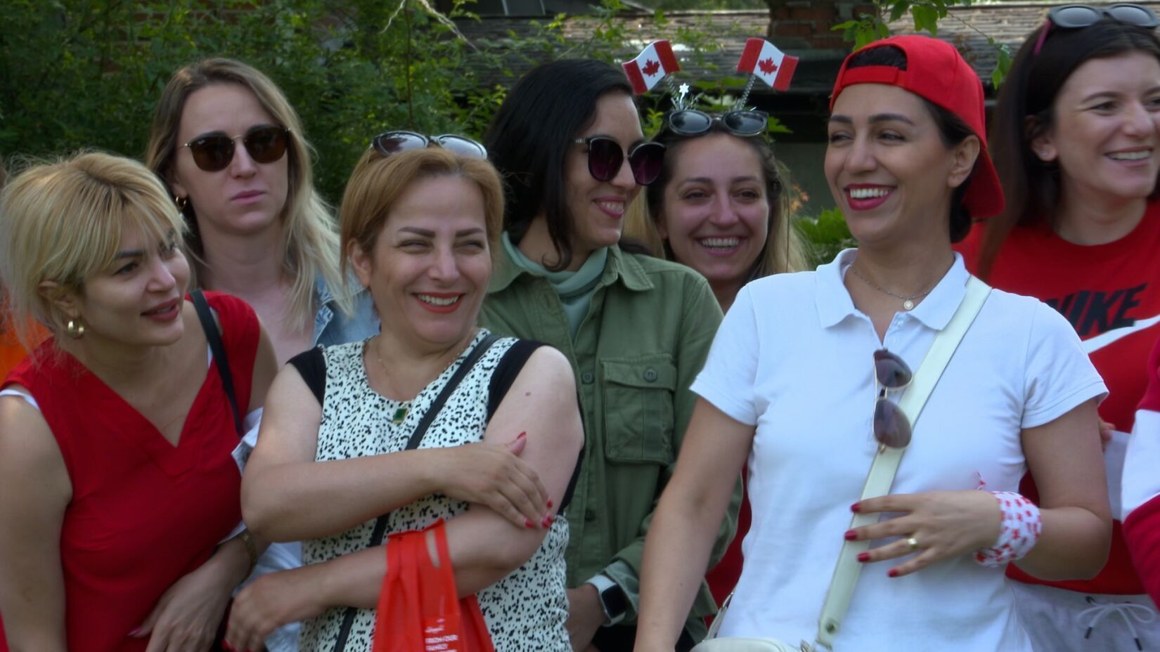 A group of women are standing next to each other and smiling.