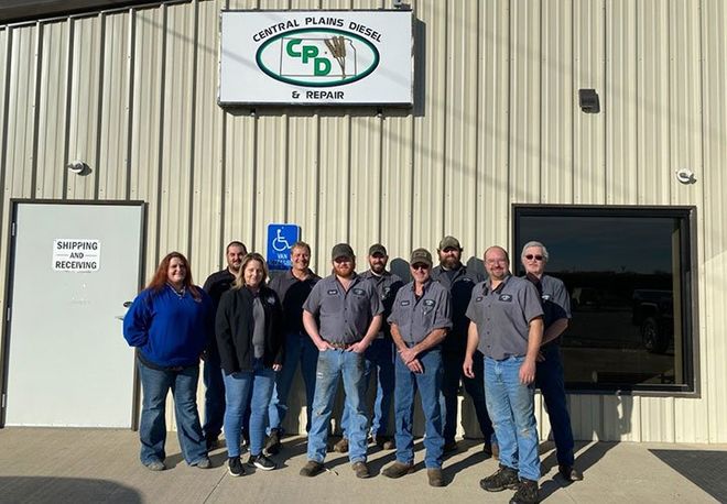 Staff from Central Plains Diesel & Repair in Salina, KS in front of their shipping and recieving warehouse