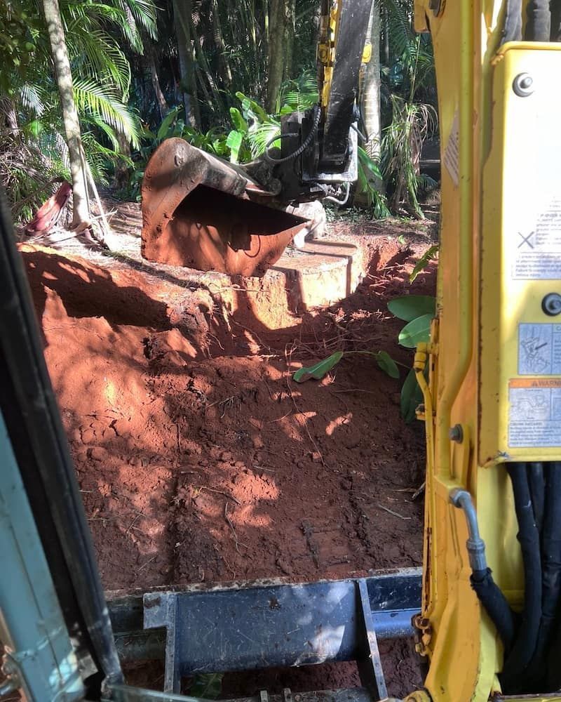 Excavator Digging a Trench in Reddish-brown Soil — Heller Excavation & Tree Services in Mullumbimby, NSW