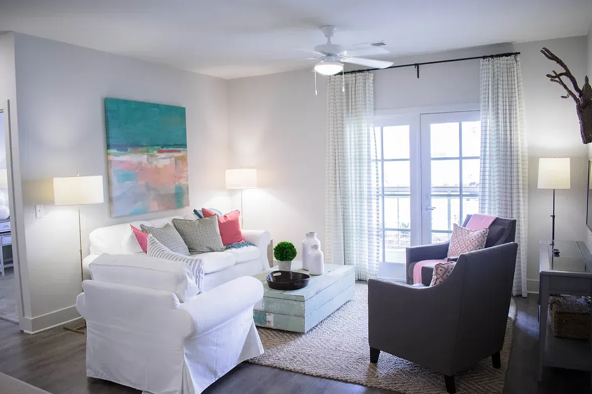a living room filled with furniture and a ceiling fan .