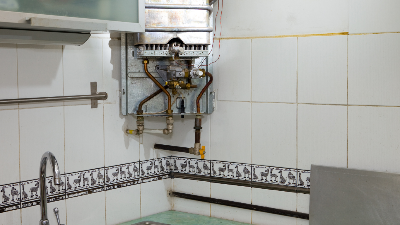 Small kitchen with wall-mounted gas water heater above a tiled sink area