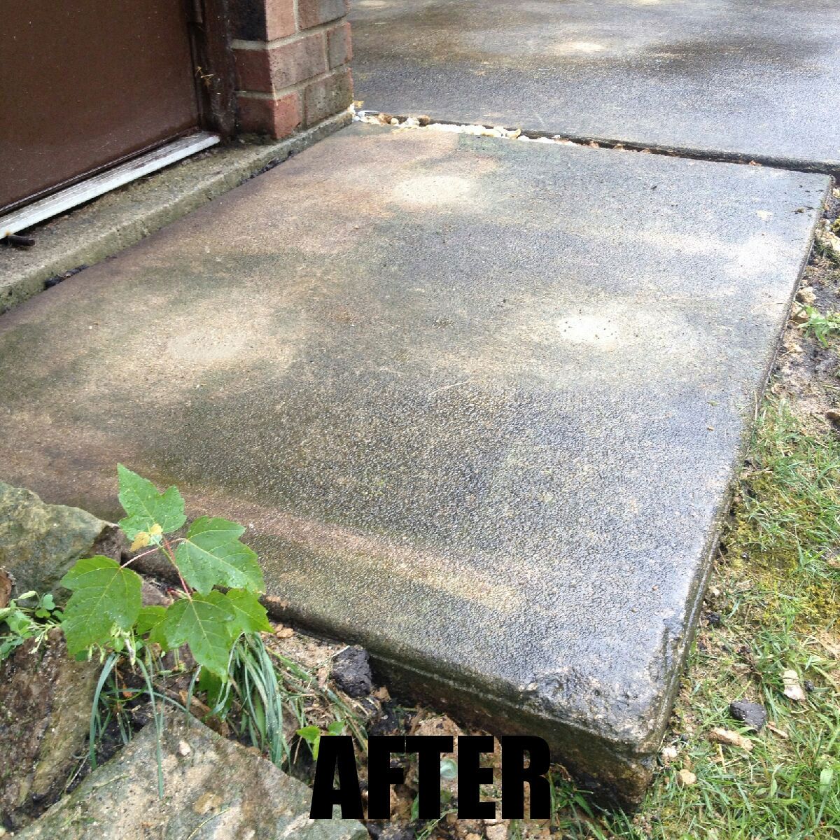 A picture of a concrete walkway after being cleaned