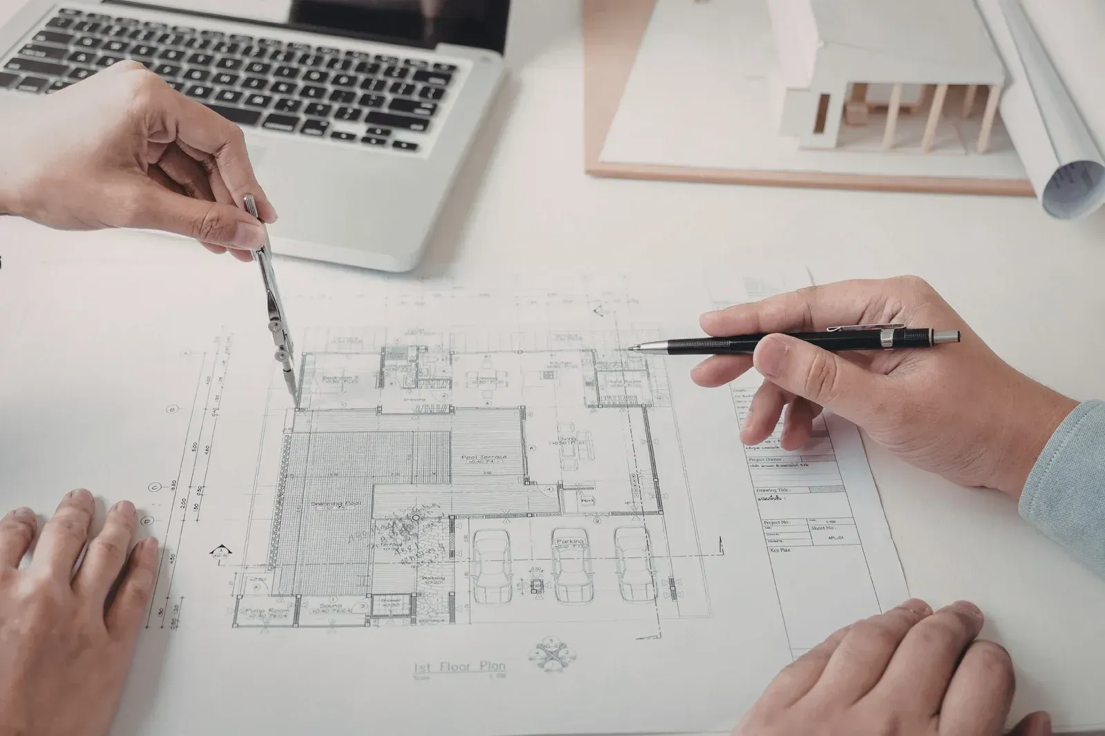 Long hallway in a modern building with marble floors and columns, natural light from large windows.