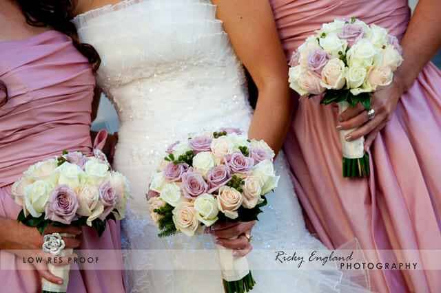 Bride and her Bride's Maid holding a flower — Tall Pines Florist in Rockhampton, QLD