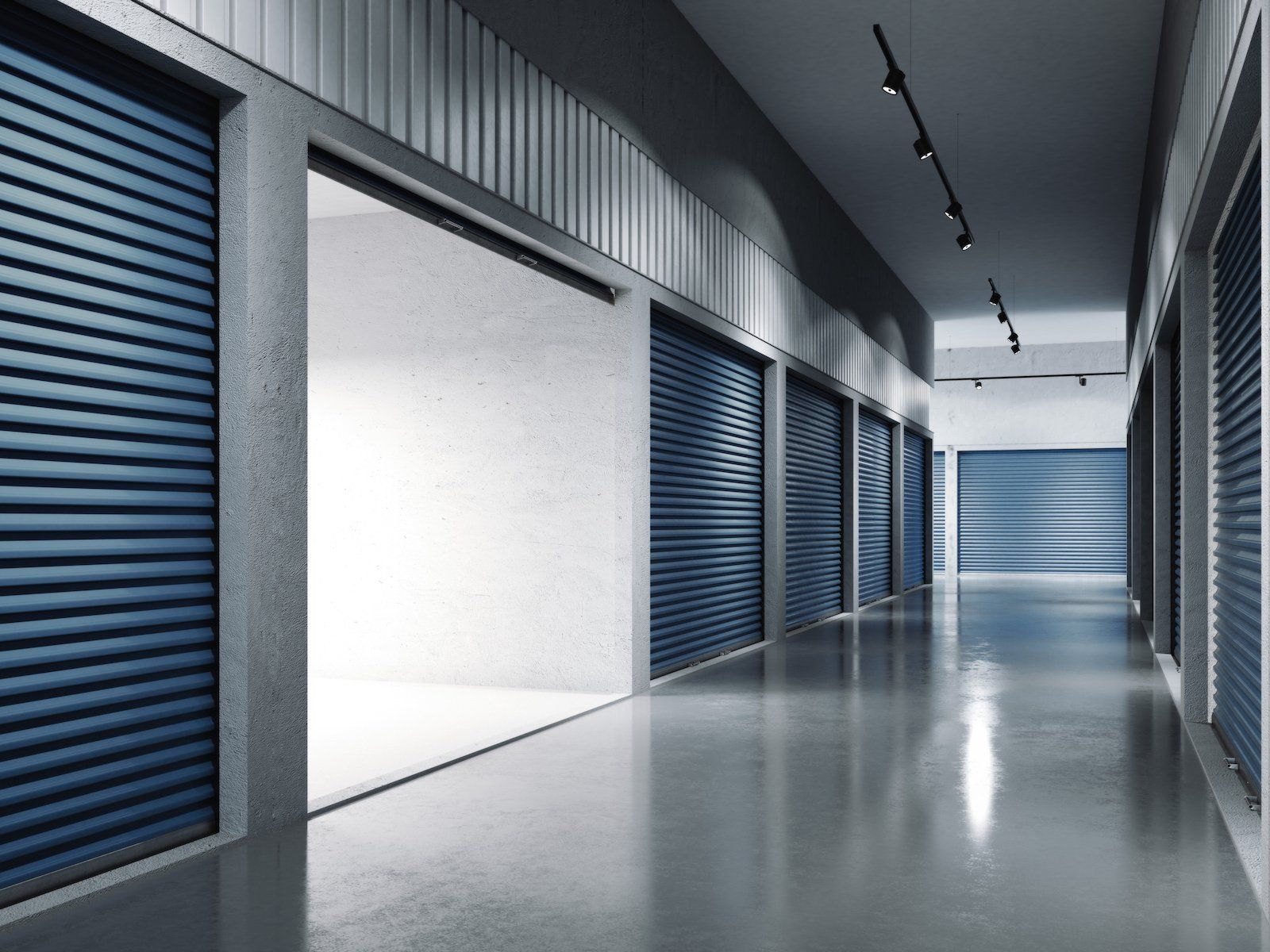 Storage facilities featuring a row of blue doors, offering organized and secure spaces for storing belongings.