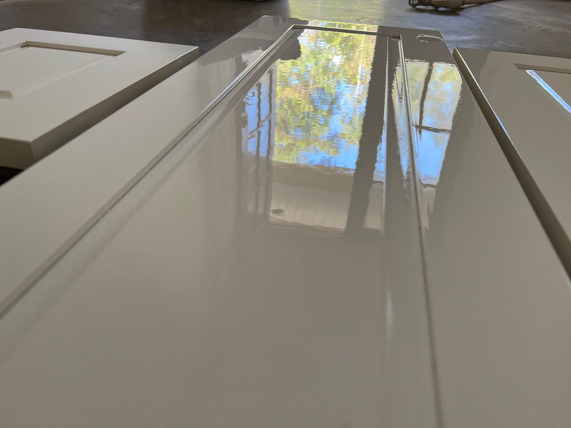 Picture of paint drying on a cabinet door. The paint will dry to a factory finish. Covington, Louisiana