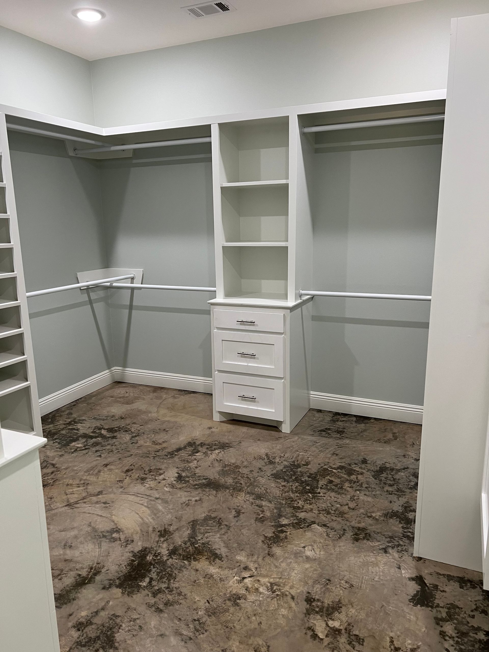 Stained concrete floor in closet. Decorative concrete work completed by Jordan's Painting LLC