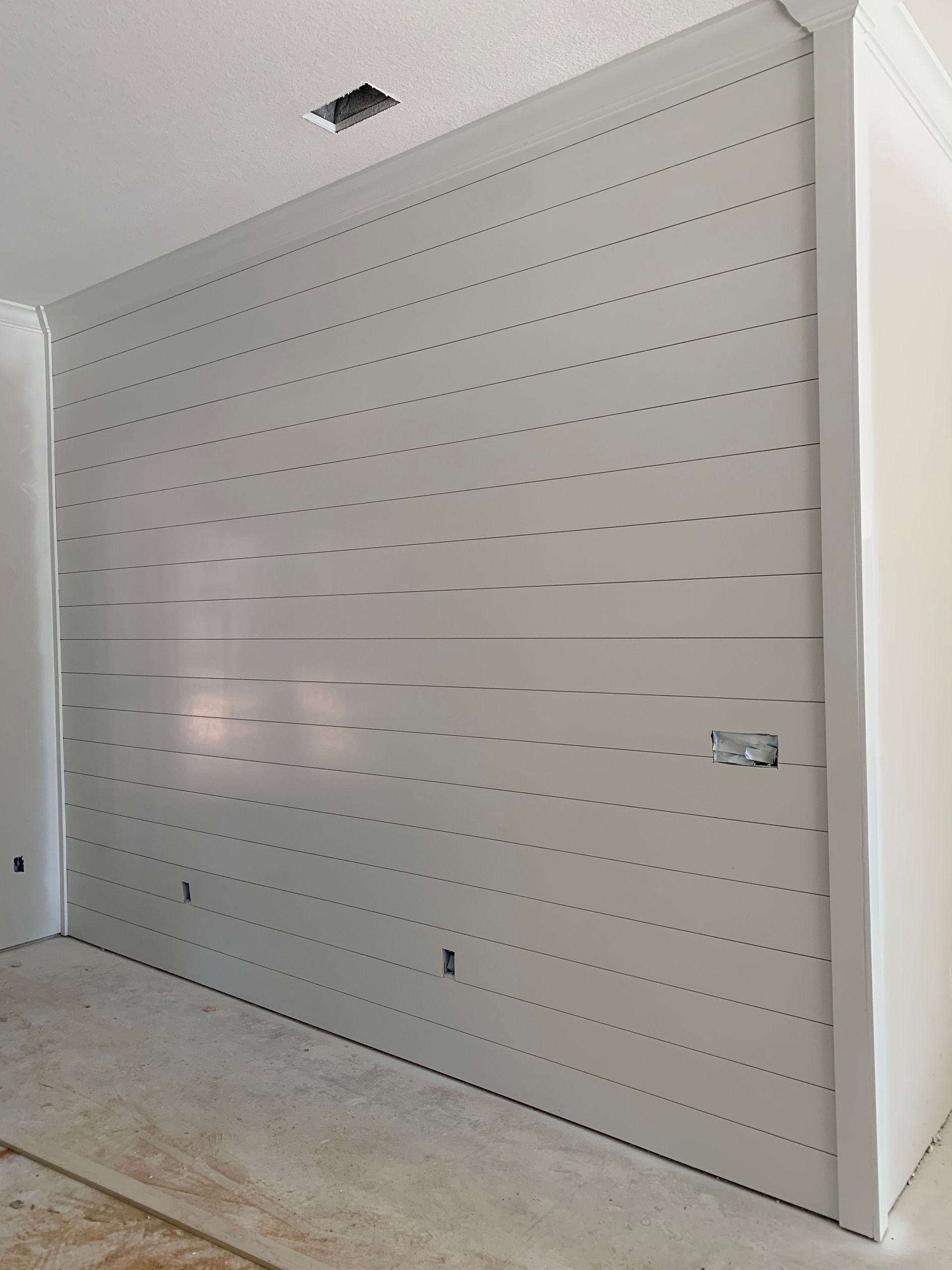 Custom shiplap accent wall painted white in Madisonville