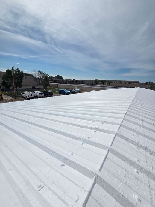 A white roof with a lot of cars parked on it.