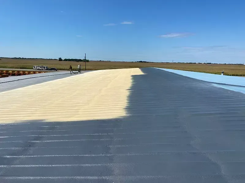 A man is working on a white roof.