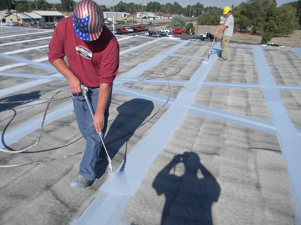 A man is working on a white roof.