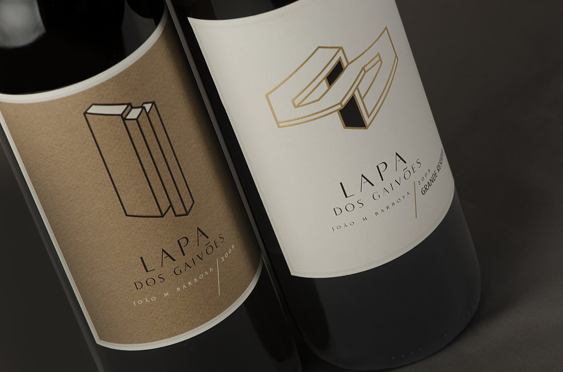 Two wine bottles with gold and white labels, 
