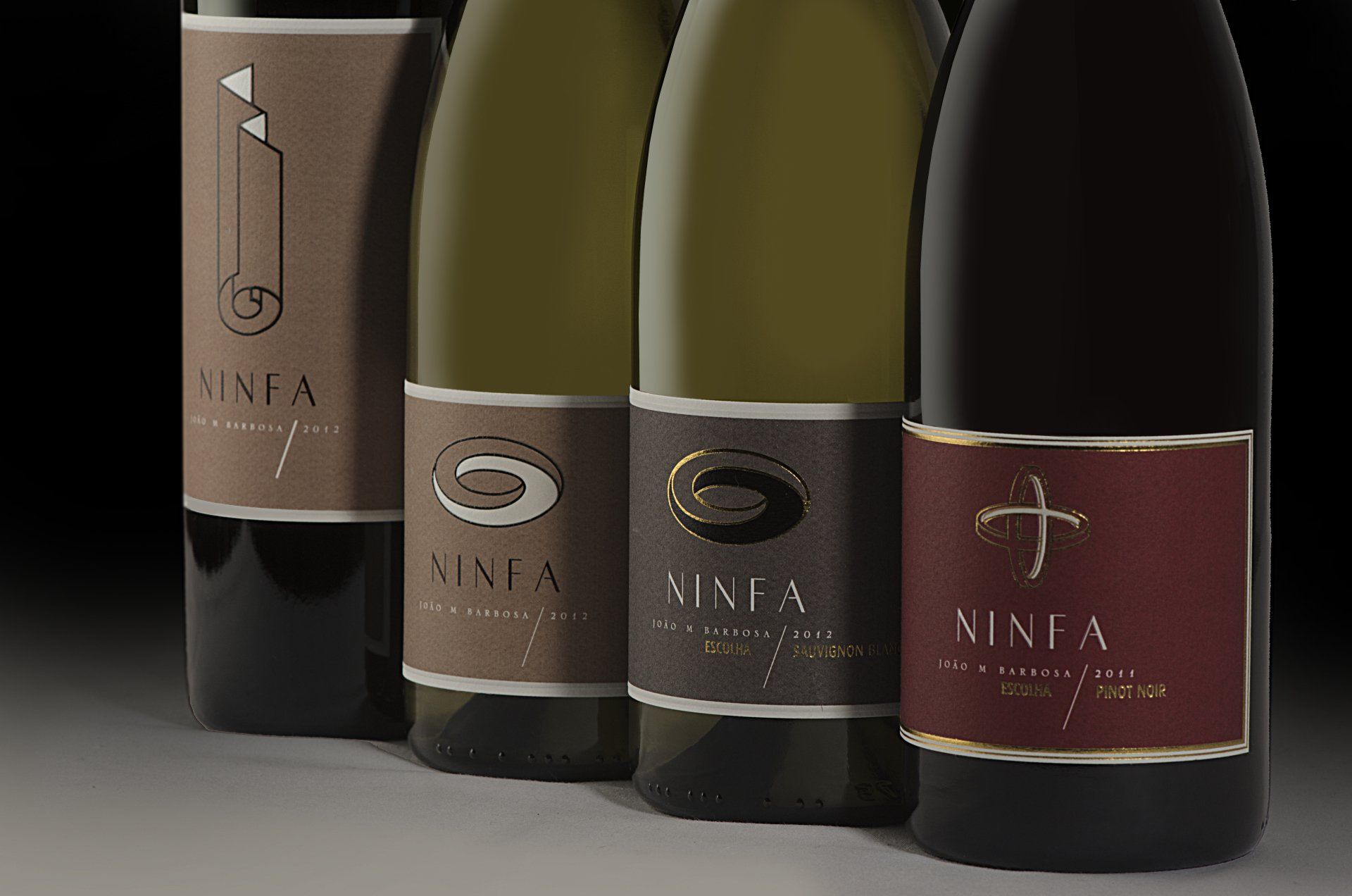 Four bottles of Ninfa wine with distinct labels, arranged in a row.