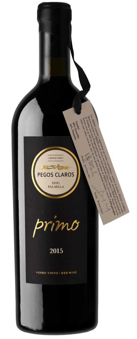 Bottle of Primo wine with black label and gold lettering, with a small tag attached.