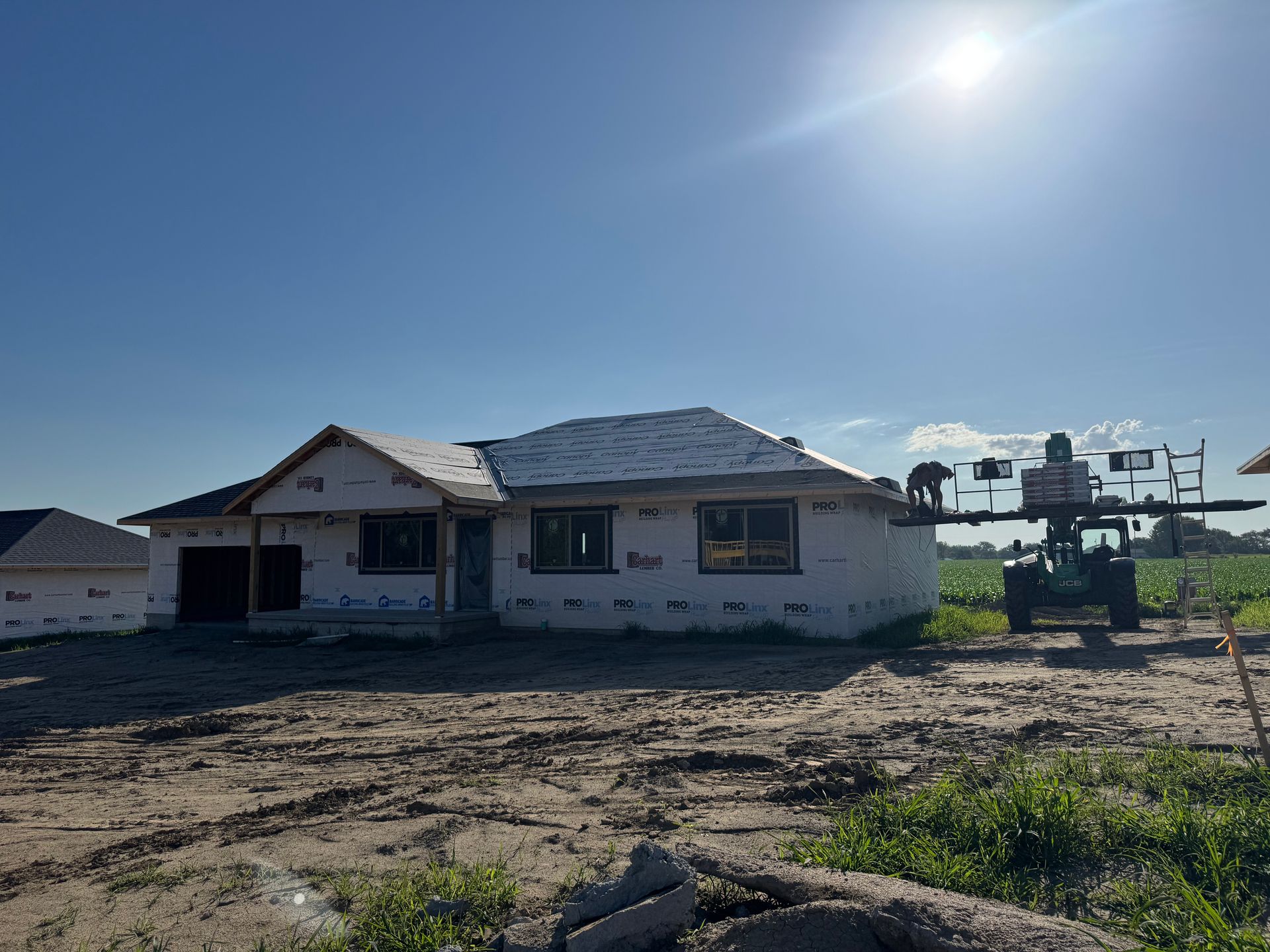 A house is being built in a dirt field.