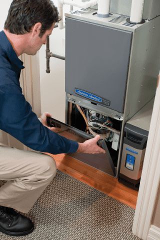 Repairman Checking Air Conditioning Unit - Heating and Air Conditioning Service in Georgetown, MA