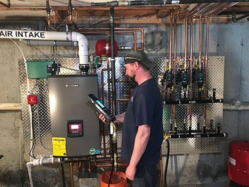 HVAC Technician Checking on Boiler - Heating and Air Conditioning Service in Georgetown, MA