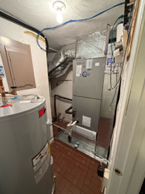 A mechanical closet containing a water heater and an HVAC air handler unit, with exposed wiring and ductwork.