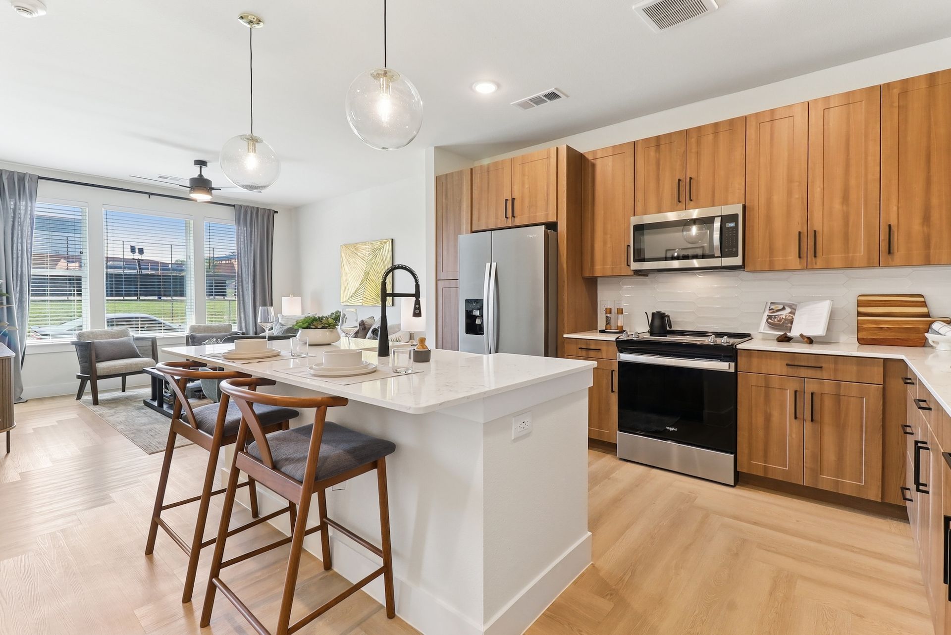 A kitchen with wooden cabinets and stainless steel appliances