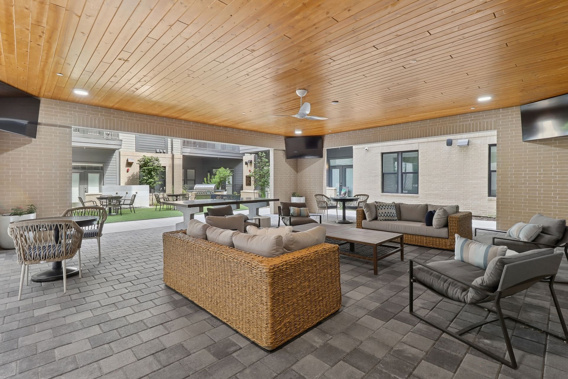 A living room with a lot of furniture and a ceiling fan.
