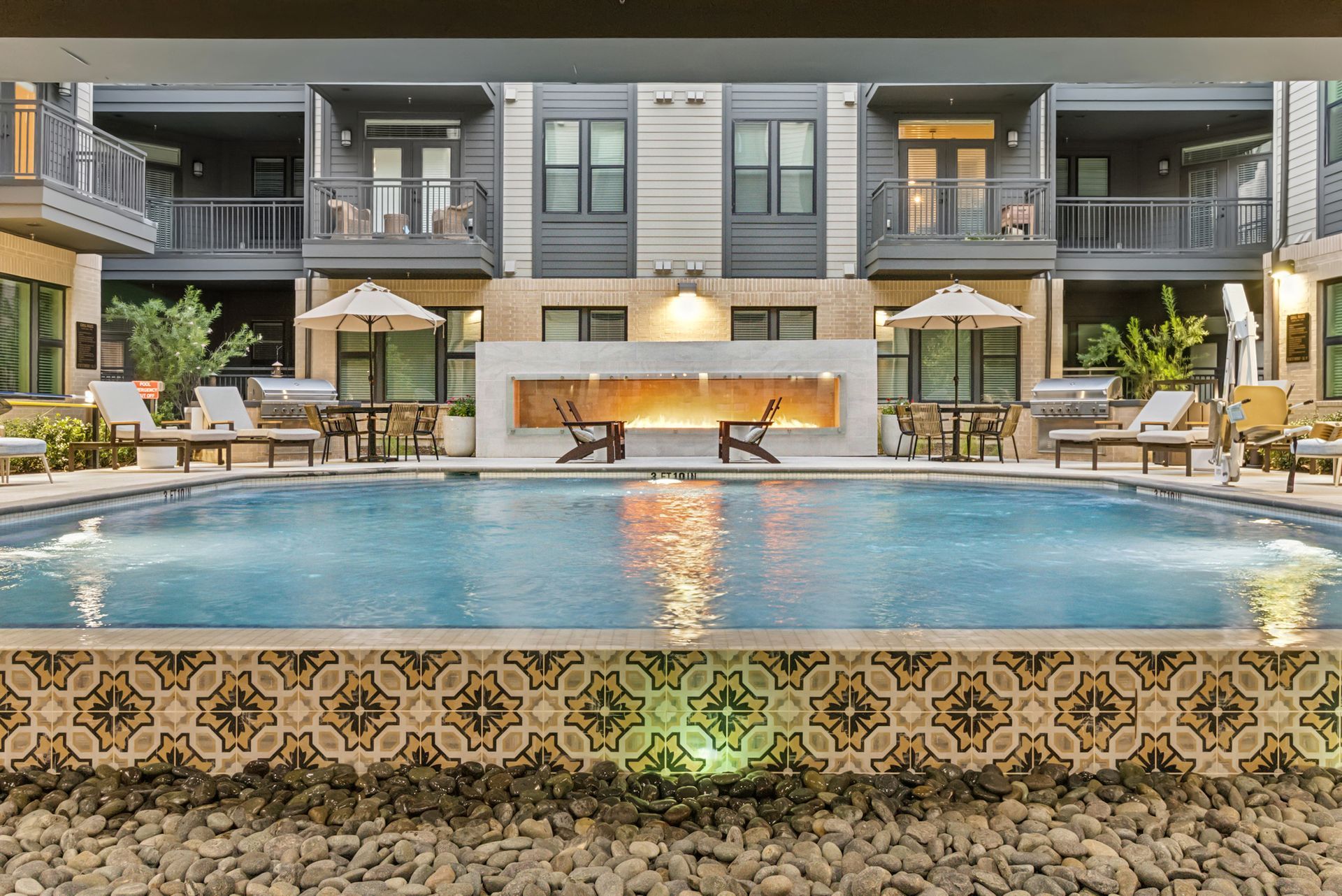 There is a large swimming pool in the middle of a building.